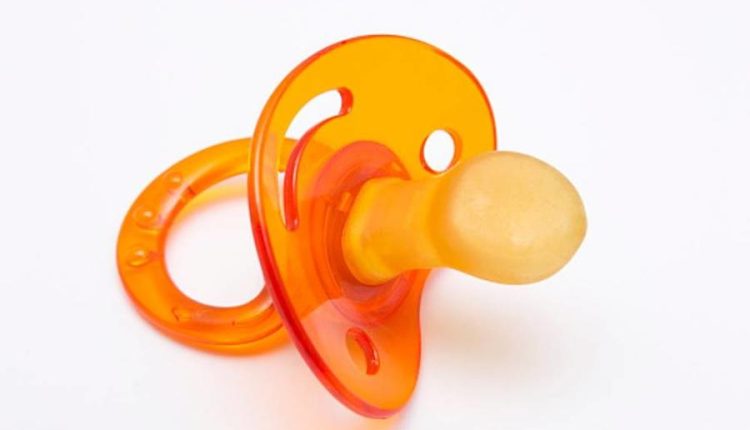 Orange Baby Silicone Pacifier on White